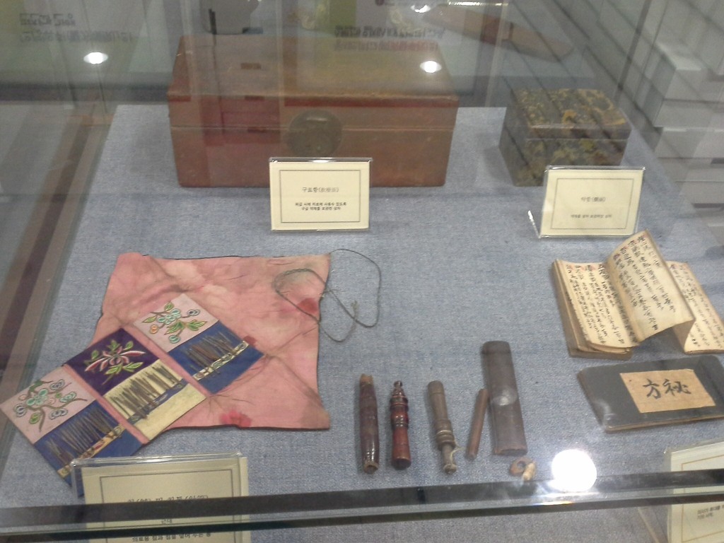 Ancient medical equipment, including acupuncture needles displayed in Korean Medicine Museum in KHU College of Korean Medicine.